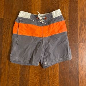 In excellent condition orange and gray boys Boden swim trunks